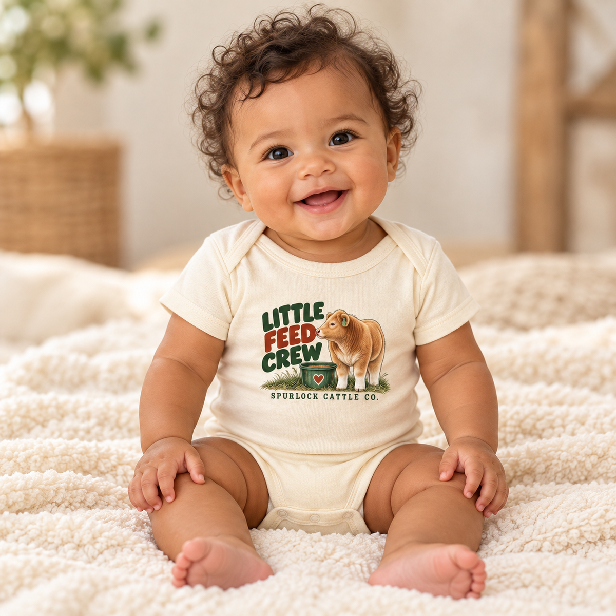 Smiling baby wearing the natural Little Feed Crew baby onesie